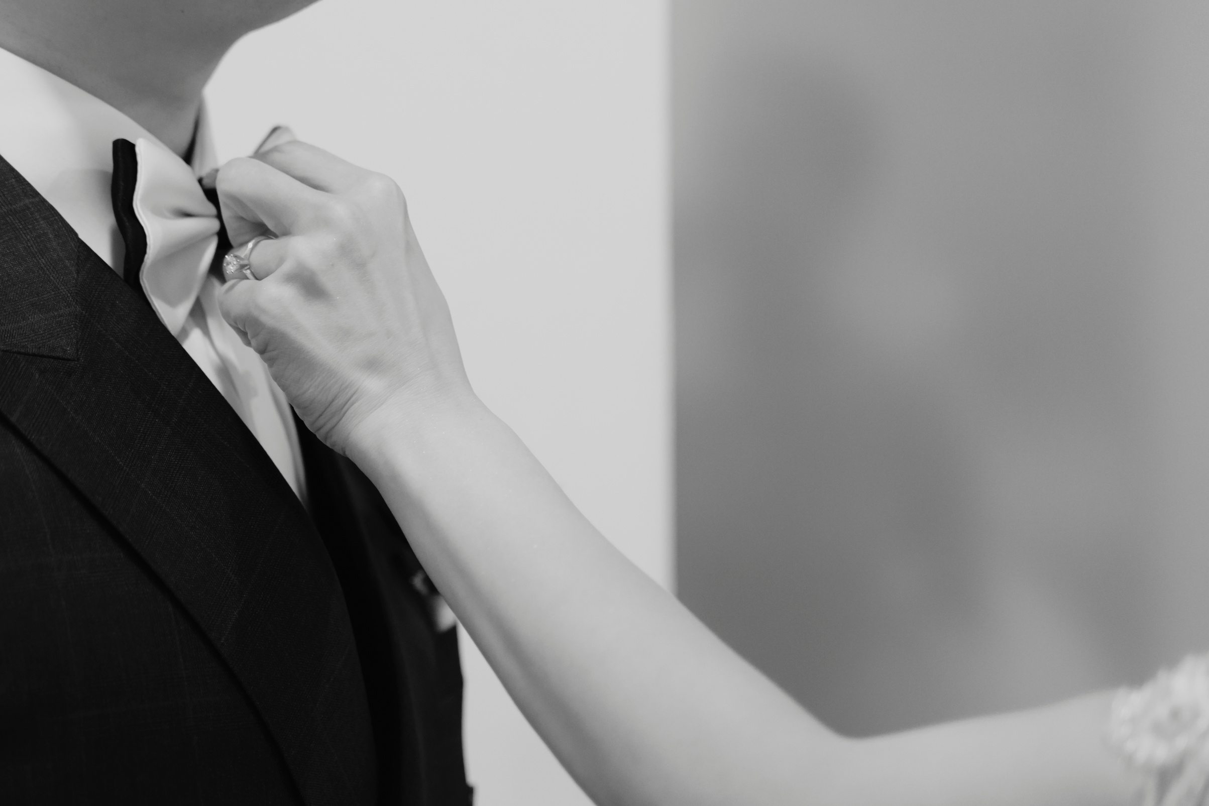 Bride Fixing Bow Tie of Groom